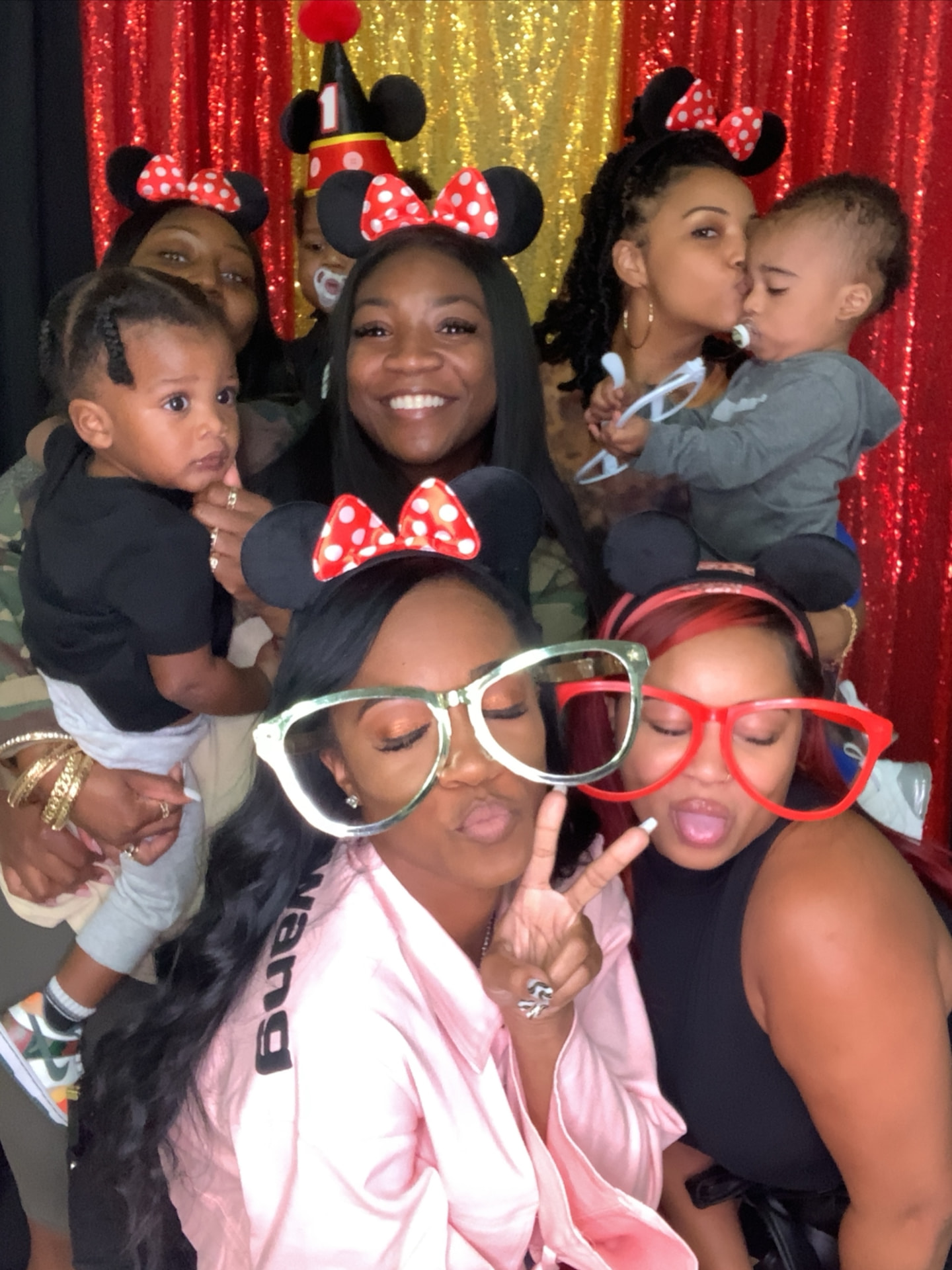 Party guests wearing Minnie ears at the photo booth