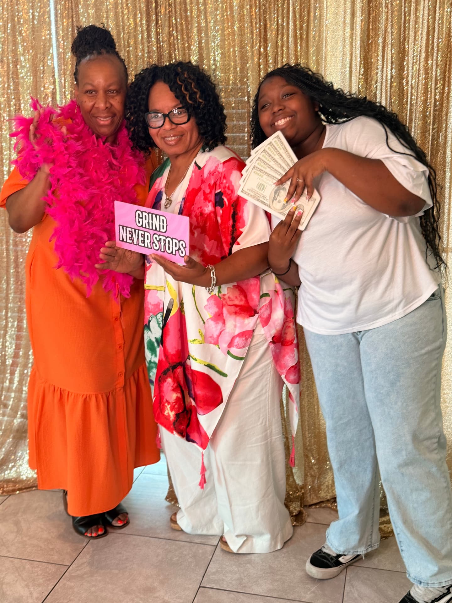 Family posing with feather boas and props at the open-air booth