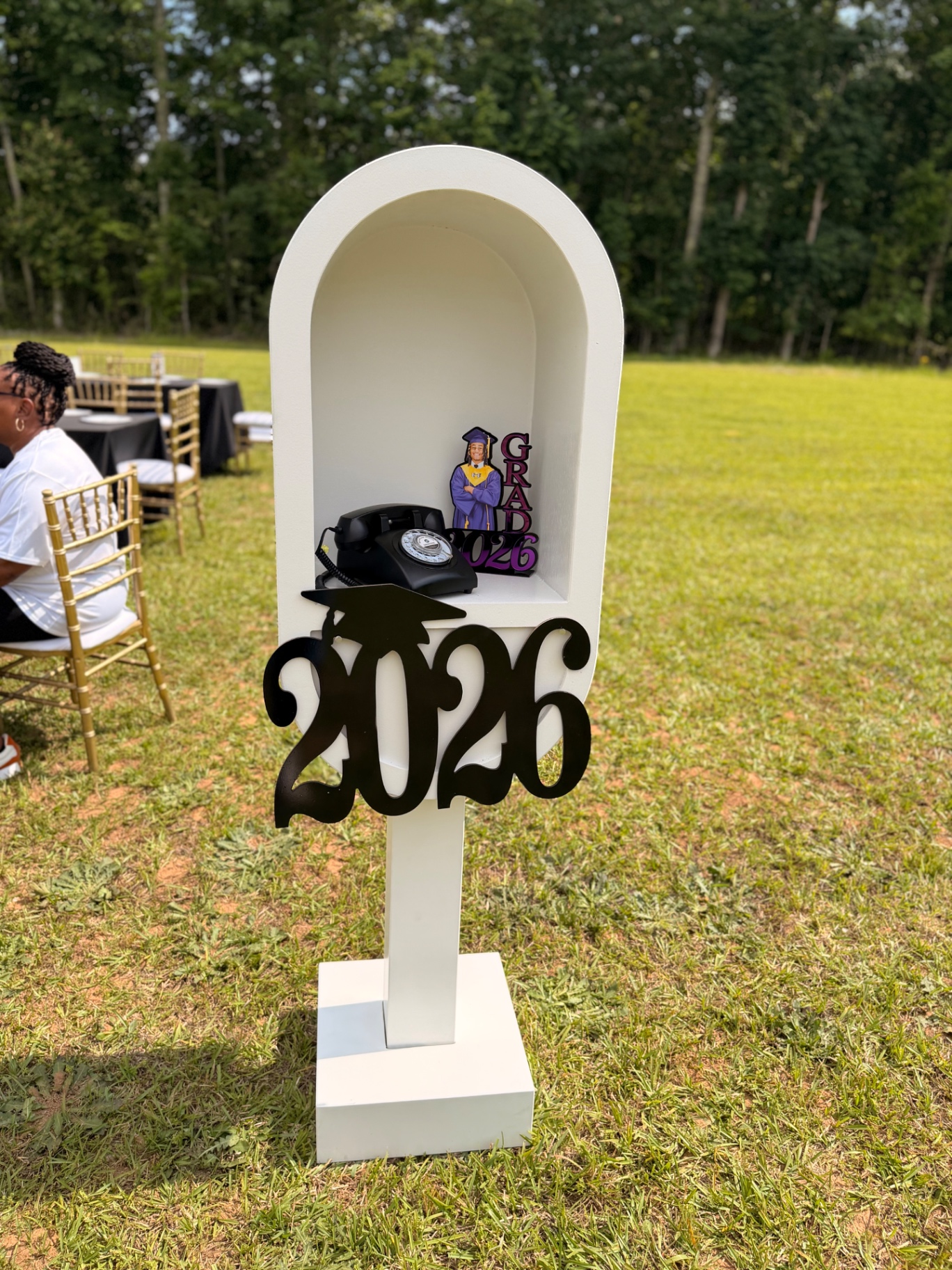 Audio guestbook arch styled for an outdoor 2026 graduation celebration