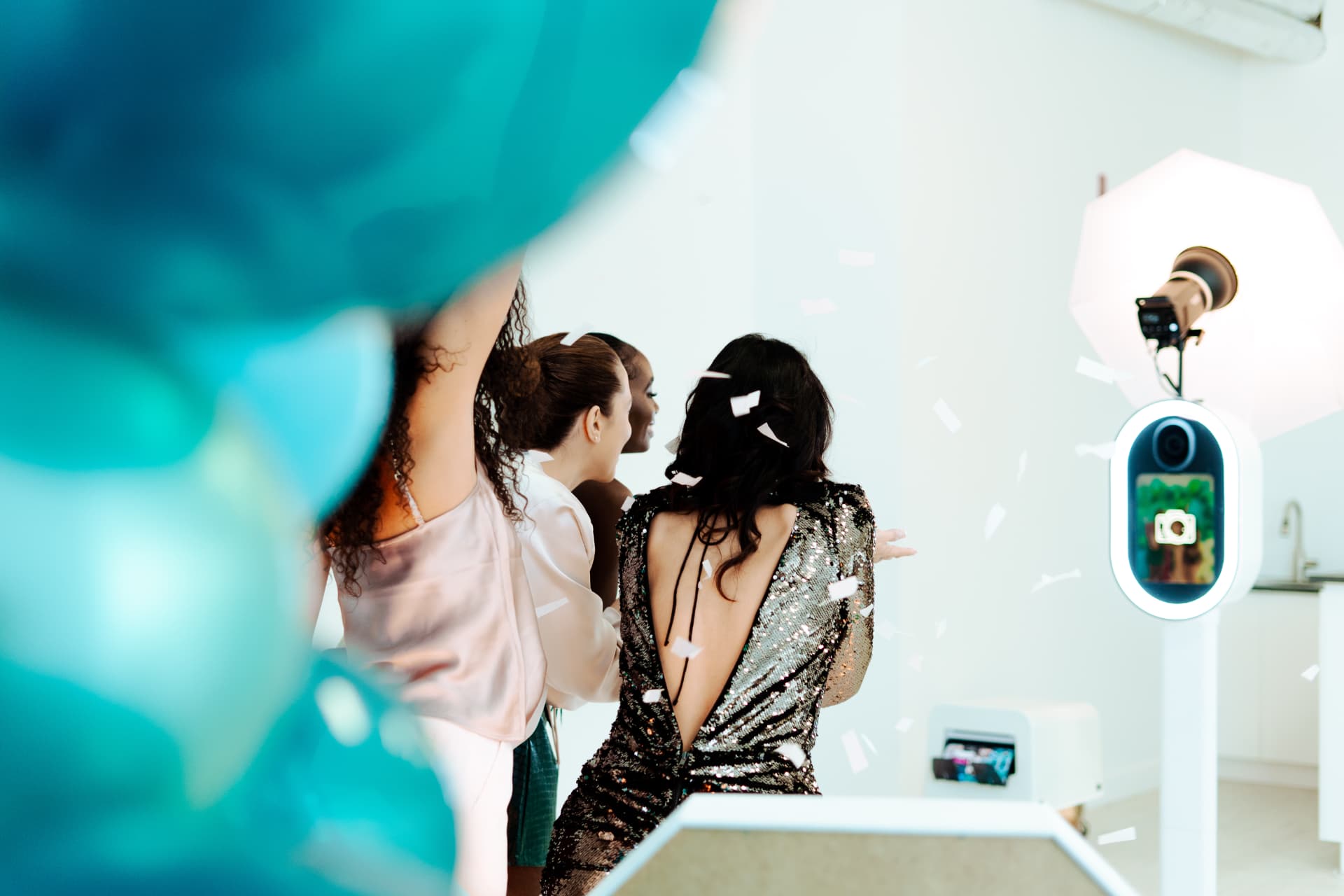 Guests cheering in confetti in front of the DSLR photo booth